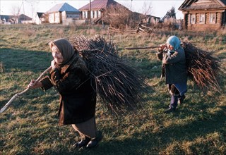 Old residents of a village in chuvashia gathering twigs to make brooms - they haven't received pensions in many months, 1999.