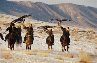 Kazakh hunters hunting on horseback with golden eagles, kazakhstan, november 1999.
