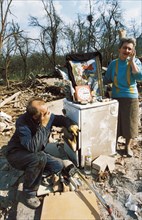 A serb couple sitting in the ruins of their home in cacak (170 km from belgrade) after a nato air strike, yugoslavia, april 1999.