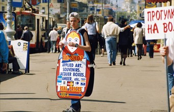 Teenage boy with a sandwich board on a street in st, petersburg, russia, 1990s.