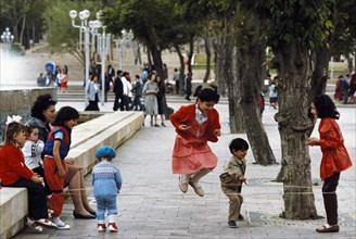 Girls jumping rope in a park in baku, azerbaijan, 1990s.