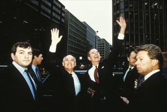 Mikhail gorbachev and george bush waving to crowds during the soviet premier's visit to the united staes in 1987.