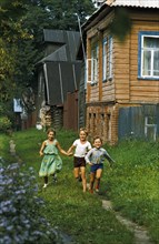 Children playing outside a dacha (country house) in karelia, russia, 1990s.