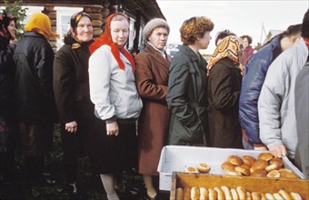 Residents of a village of berezkino in the kirov region of the ussr line up to buy rolls on may day eve during the times of economic reforms, 1990.