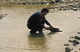 A prospector panning for gold in the kozhim river in the komi region of russia, 1990s.