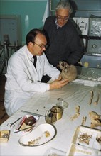 Forensic experts n, nevolin and a, avdonin examine the remains of the romanov family in yekaterinburg, russia, 1992.