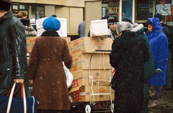 Various street peddlers selling goods of dubious origin outside of the kievsky railroad terminal in moscow, russia, january 1994.