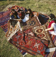 Carpet weavers of daghestan displaying their handicraft, russia.
