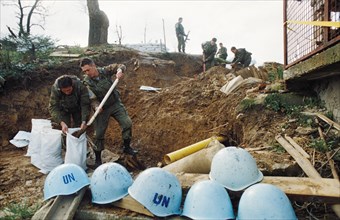 Russian un peacekeeping troops filling sandbags to fortify their outpost in yugoslavia, may 1994.