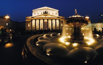 Fountain outside of the bolshoi theater lit up at night in moscow, 2000s.