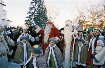 Grandfather frost (ded moroz) and his lappish colleague, santa claus with school children in the vologda region, november 2000.