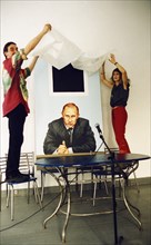 Artists victoria timofeyeva and dmitry vrubel unveiling their joint project, a painting of president putin with k, malevich's 'black square', july 2002.