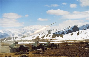 Afghan government troops attacking mujahadeen-held village of mohammed aga with soviet-made rocket launchers, abbazak mtn, pass, afghanistan, march, 1990.