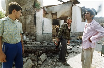 An opposition fighter and residents of the budenny state farm in tajikistan, september 1992.