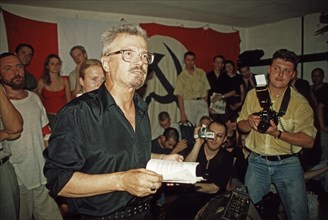 Eduard limonov, leader of the national bolshevik party, reading at the 'children's book of the dead' literary soiree which was held along with the poet alina vitukhnovskaya at the party's premises in ...