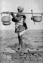 Historical Geography. 1900. India. Pious pilgrim returning with the holy water.