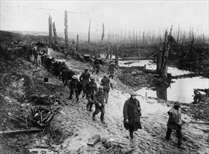 British troops crossing a muddy area.