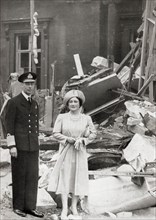 King George VI and Queen Elizabeth outside Buckingham Palace which suffered bomb damage on 13 September 1940