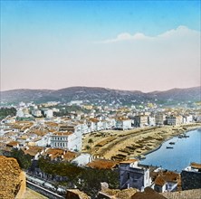 Coloured image of a Mediterranean town with boats in the tranquil water and hills in the distance