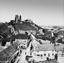 A black and white historic image of a city with a landmark on a hilltop