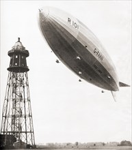 The final flight of the British rigid airship R101 which crashed during bad weather conditions over France in 1930.  48 of the 54 people aboard perished in the accident.  From These Tremendous Years