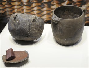 Pottery, Bowl with repair holes; Jug with spout and spouted handle and Body sherd of a recycled vessel and ochre