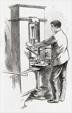 A worker at the coining press, the Royal Mint, London,