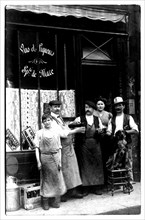 People outside bar in paris circa 1900, postcard. parisian coffee shops and restaurants served the culinary, social life in paris. they were oftenvisited by famous writers and poets.