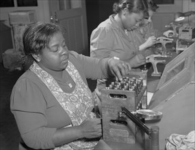 Production. Aircraft engines. Negro women with no previous industrial experience are reconditioning used spark plugs in a large Midwest airplane plant.