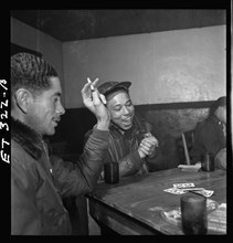 Tuskegee airmen playing cards in the officers' club in the evening