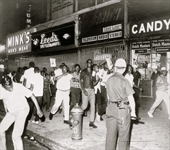 The fatal shooting of Powell stirred Negro rioters to race through Harlem streets carrying pictures of Lt. Gilligan