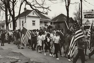 Participants, some carrying American flags, marching in the civil rights march from Selma to Montgomery, Alabama in 1965