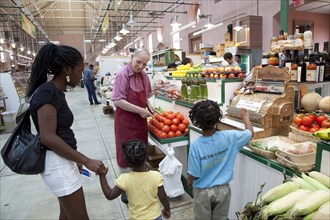 African American mother with Children Buys Fruits & Vegetables