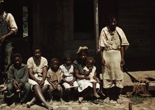 Bayou Bourbeau plantation, a FSA cooperative, Natchitoches, La. A Negro family seated on the porch of a house