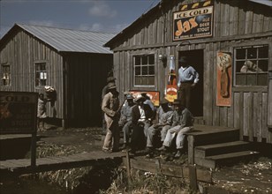 Migratory Workers outside a "juke joint" for migratory workers, a slack season; Belle Glade, Fla.