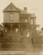 Home of an African American in Atlanta, Georgia, with man, woman & Boy in front of house