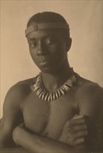 Young man with headband and necklace