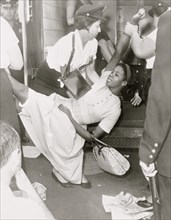 African American woman being carried to police patrol wagon