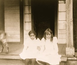 Two African American girls sitting on a porch