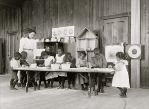 Children, in kindergarten, learning washing and ironing