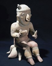 Sitting male figurine.