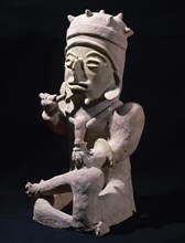 Male figure sitting cross-legged and hands objects.
