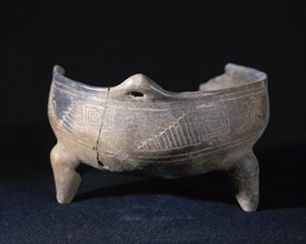 Ceramic vessel decorated with incised geometric motifs.