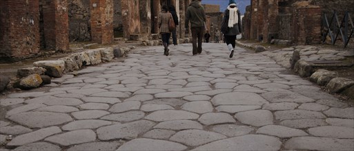Pompeii. Tourists in the cobbled street.