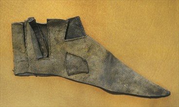 Upper of a shoe, ca. 1200 to be laced on the side.