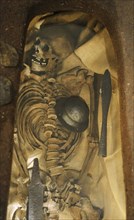 Male grave find from the 8th century. Skeleton and grave goods.