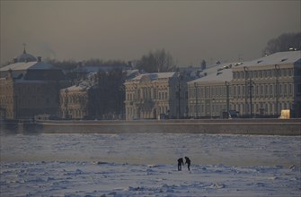 People walking on the frozen Neva river during the winter surface.