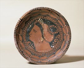 Ceramic plate. Decorated head matron. Greek imitation. 3rd c.BC. From Bari, Italy. Episcopal Museum. Vic. Spain.