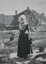 Girl watering in the home garden