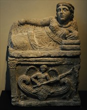 Roman cinerary urn with a reclining female figure at the top